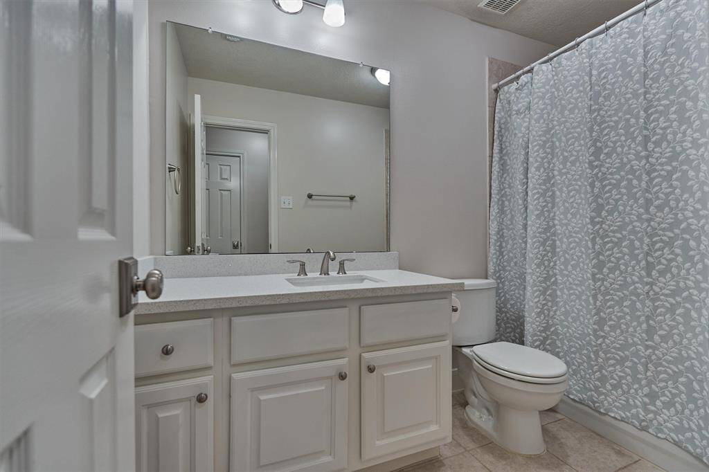 Secondary bedroom #2 features plush carpeting, ceiling fan, and walk-in closet. Note: access to Jack & Jill bathroom.