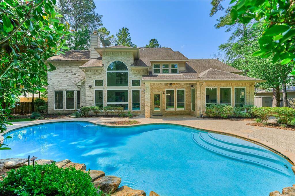 Relax underneath the shade of the covered back patio with ceiling fan!