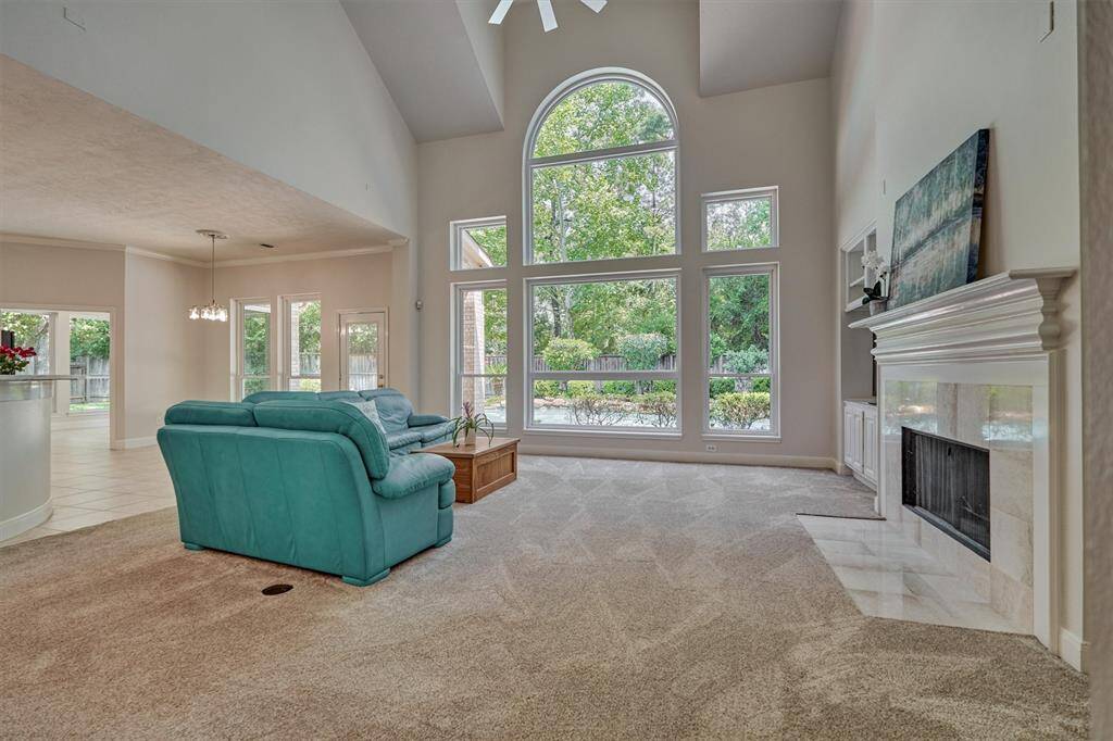 Enclosed home office and formal dining room are situated just off the grand foyer entrance. Note the crown moldings, capped columns, and transom window above the French doors.