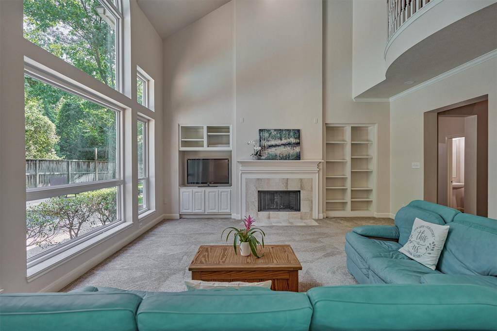 Formal dining room boasts arched windows with plantation shutters for custom appeal, and glistening wood floors!