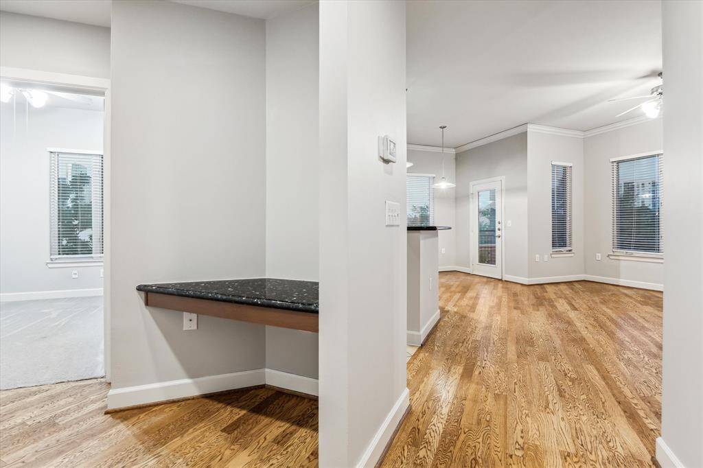 A tucked-away office nook offers the perfect workspace, featuring the same sleek granite found in the kitchen—blending style and continuity throughout the home.