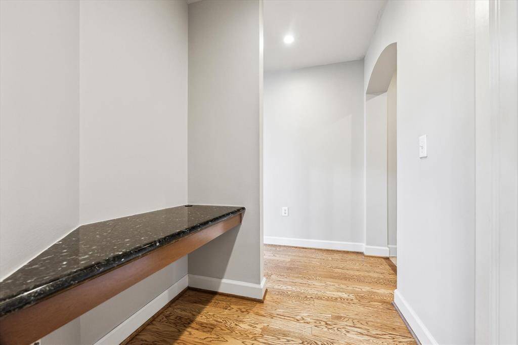 Another view of the office nook, beyond the arch is the front door, entryway and storage closet.