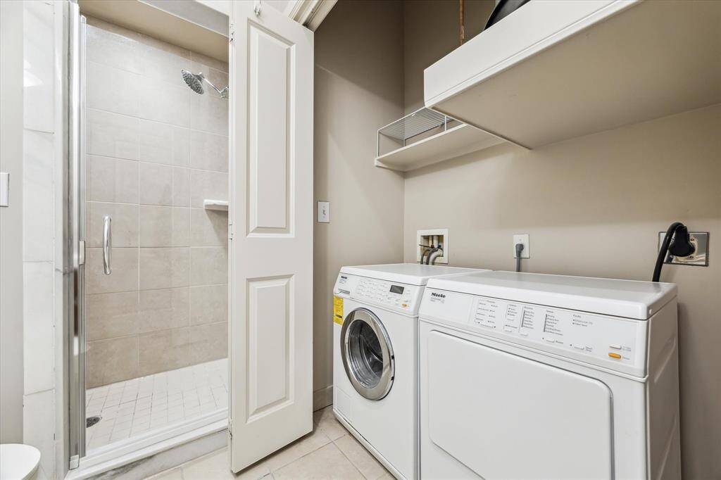 Also in the secondary bathroom, you'll find a washer and dryer conveniently located behind the double French closet doors.  Miele brand washer & dryer are included in the sale.
