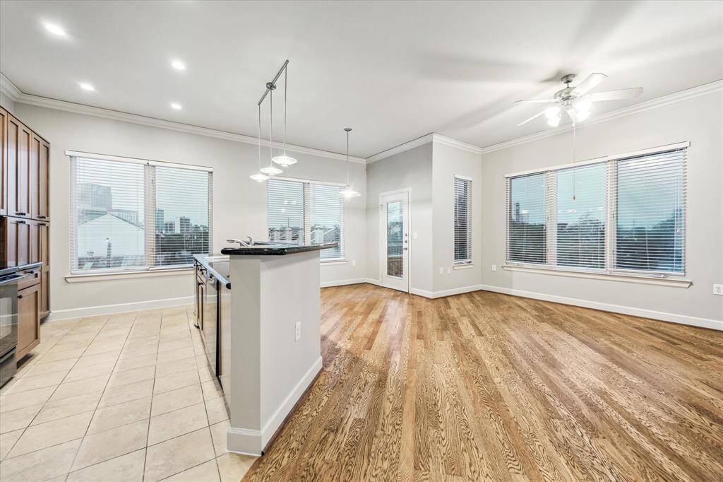 Windows galore!  The windows on the left showcase the skyline view while the right-side bank of windows overlooks the pool!  All windows throughout the unit have been upgraded with 2" blinds for privacy.  Door off of the breakfast room leads to private balcony.