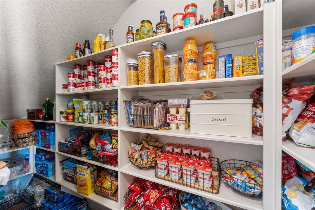 This photo showcases a well-organized pantry with ample shelving for food storage.