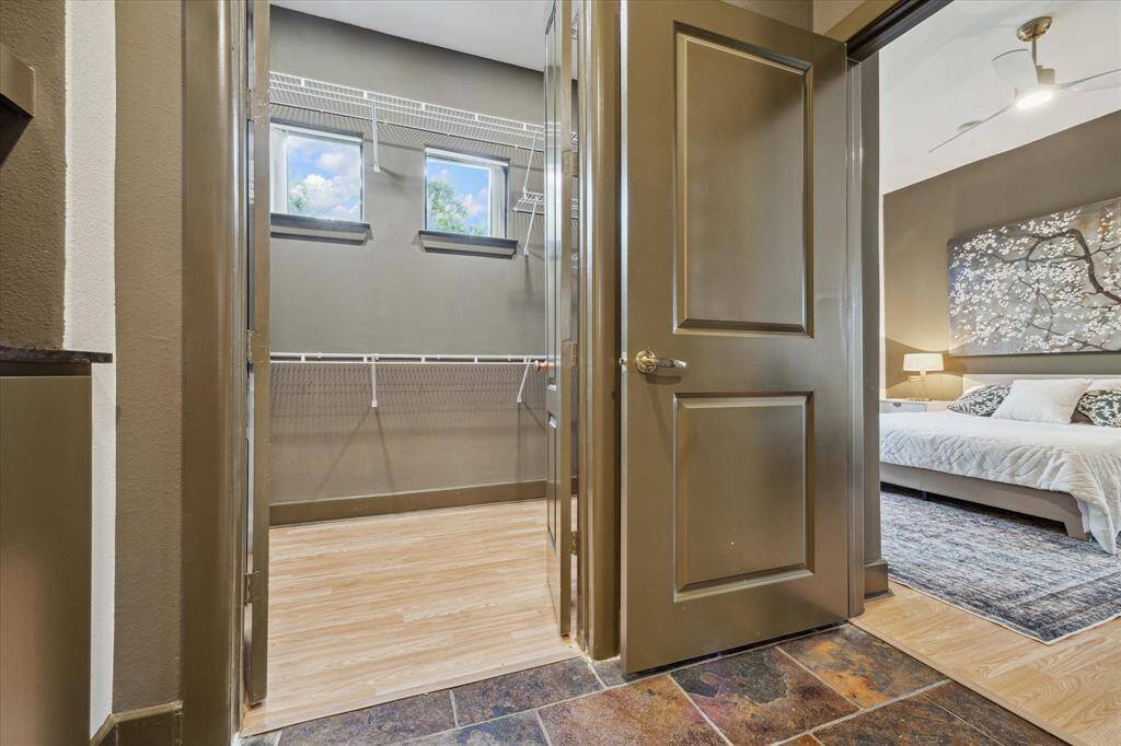 Walk in closet with small windows that give it natural lighting