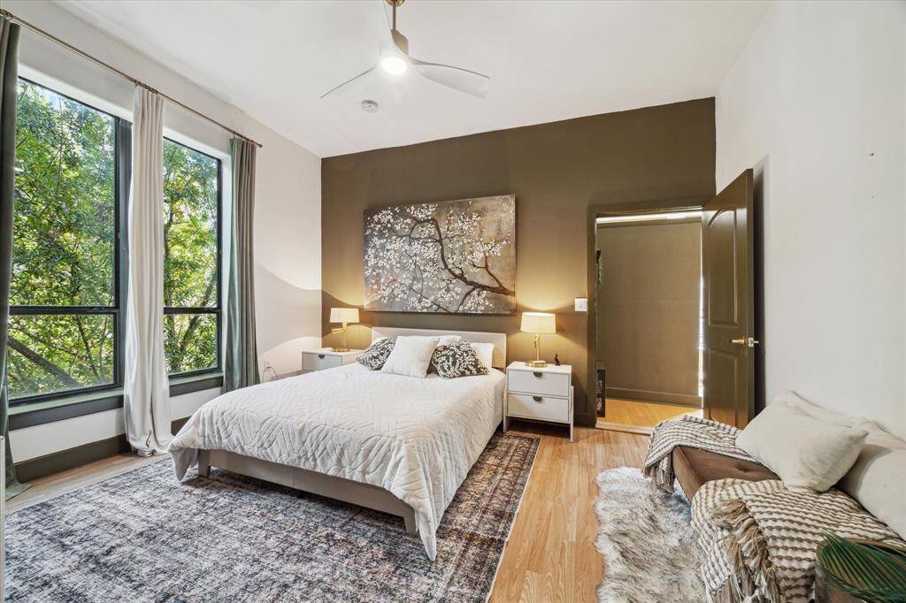 The bedroom features a large window with a view of greenery, perfect for a peaceful retreat!