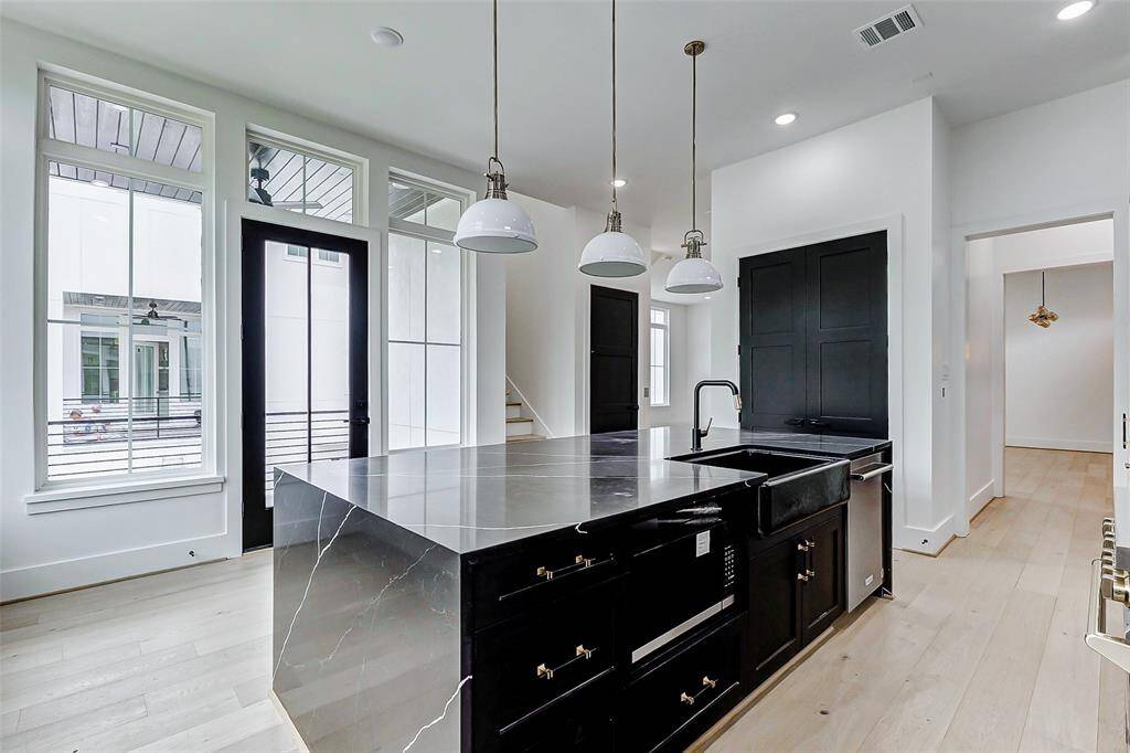 Designed with both style and functionality in mind, this kitchen is a chef's dream. Featuring sleek countertops, premium appliances, and a spacious island, it opens to the expansive living and dining areas.