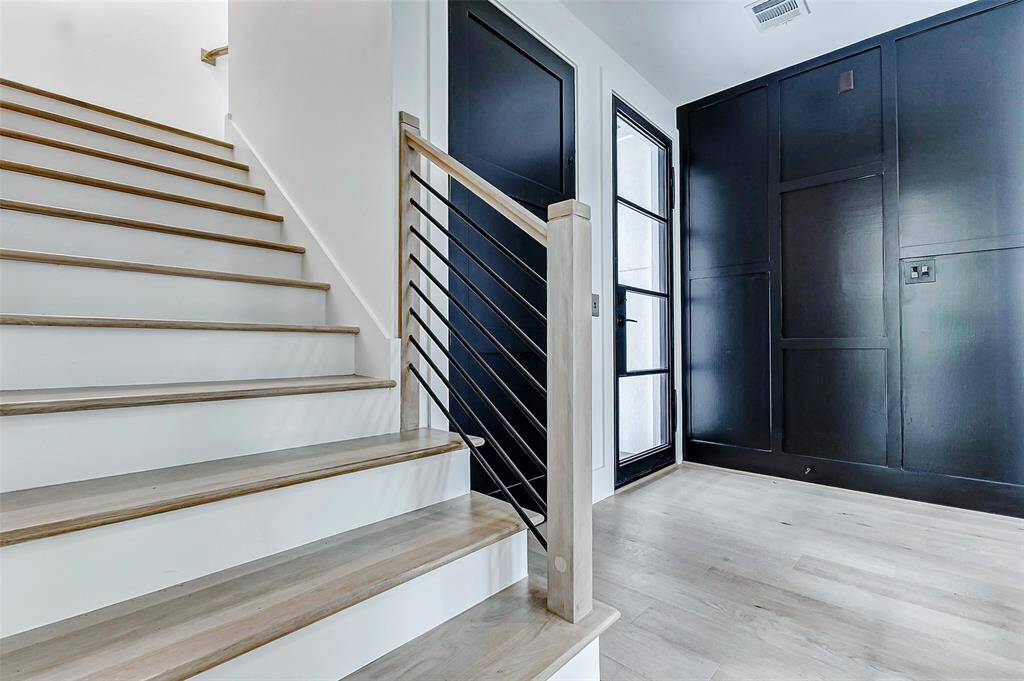 This sophisticated entryway sets the tone for the open-concept layout, offering a seamless flow into the rest of the home.