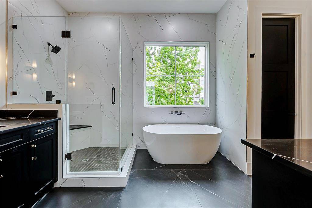 The primary bathroom is designed for relaxation and style, featuring a spacious garden tub, perfect for unwinding.