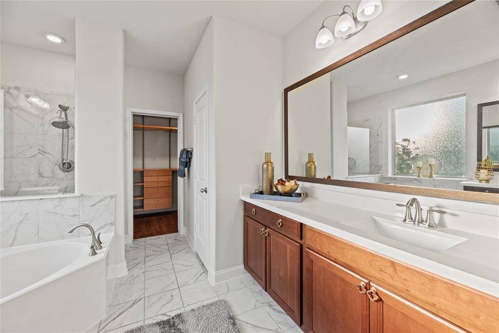 The primary bathroom is complete with 2 vanities, soaking tub, separate shower and walk-in closet.