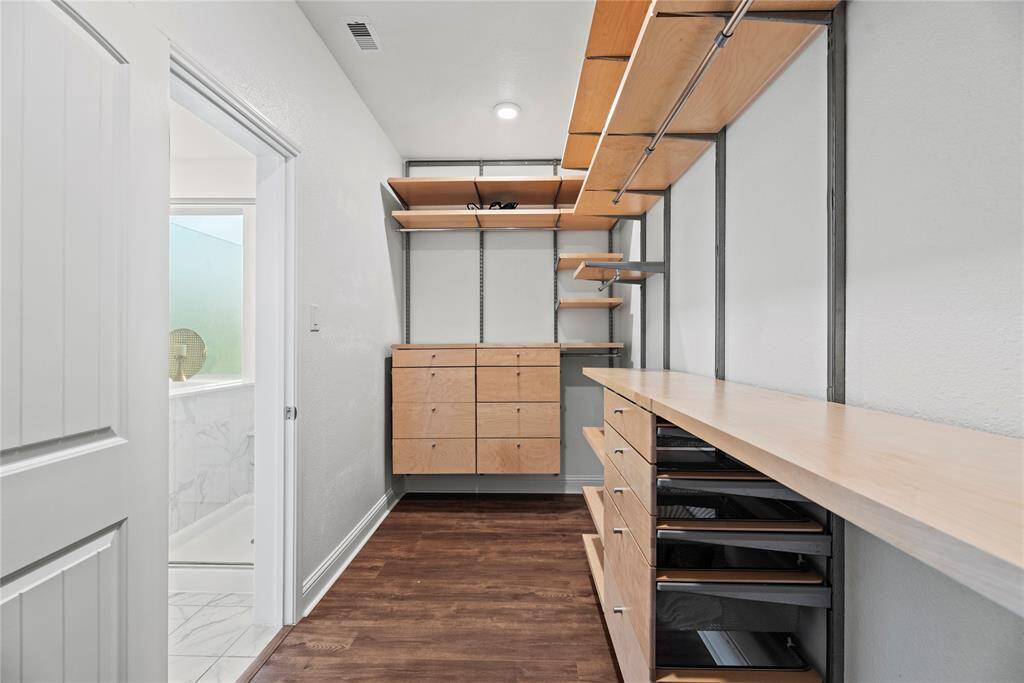 Primary walk-in closet with custom built-ins.
