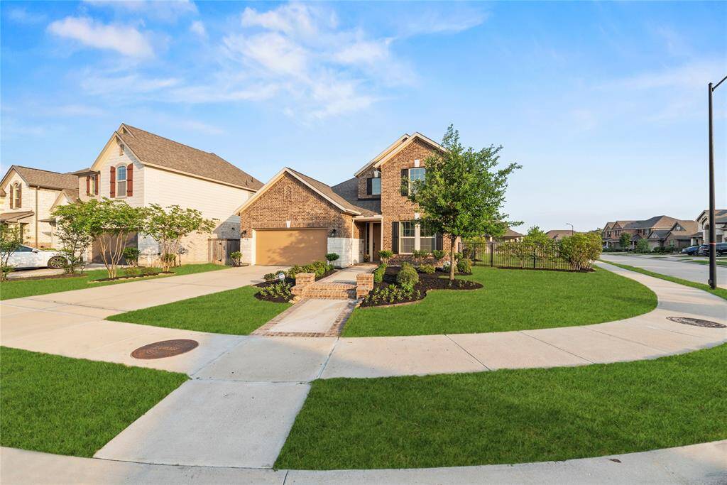 Lovely 2-story home on a large corner lot with a 2-car attached garage and double-wide driveway.