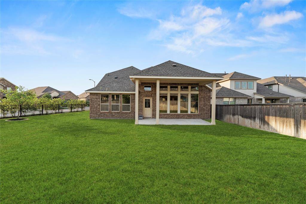 Huge backyard with a covered patio.