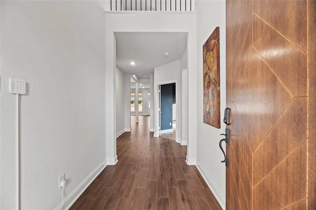 Inviting front entry with wood-look tile flooring and high ceilings.