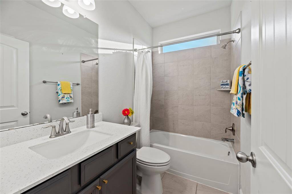 Full guest bathroom downstairs with a tub/shower combination.