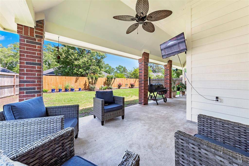 Covered patio to relax at the end of the day!  Plus, Well-manicured back yard