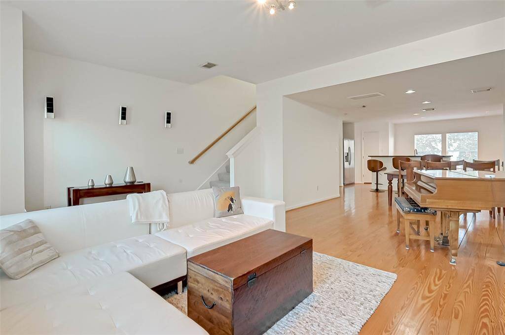 The open concept living area on the 2nd floor is perfect for entertaining with extra windows allowing abundant natural light and flowing into the dining room and kitchen.