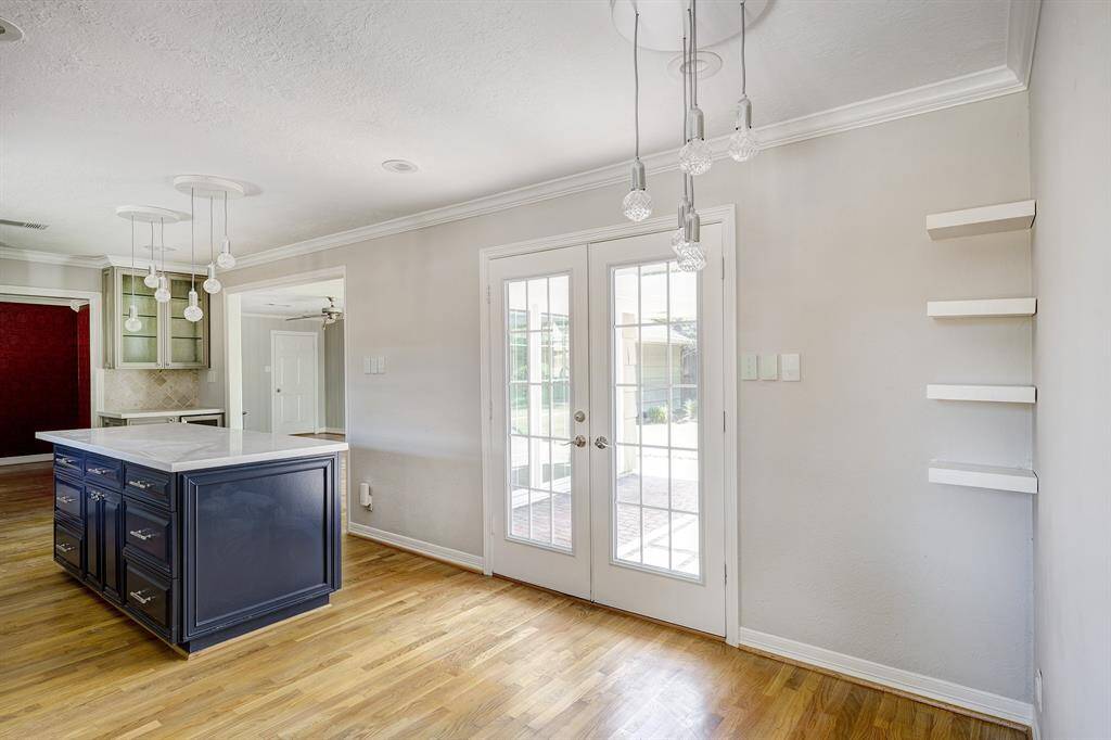 Beautiful french doors lead to the patio from the kitchen. Lots of room for a table & chairs. To the left is the den.
