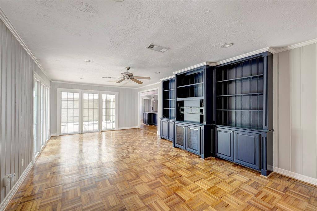 This is the den/family room off of the kitchen. Great built-in custom wood cabinetry to accommodate flat screen tv, books, art... Once again, beautiful light filters throughout the home.