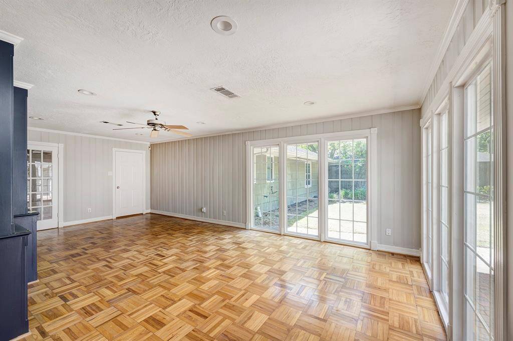 The den has beautiful neutral paint and stunning views of the patio and backyard. French doors seperate the den from the front living area.