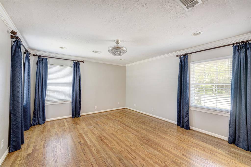 The primary bedroom with wood blinds and attached bath.