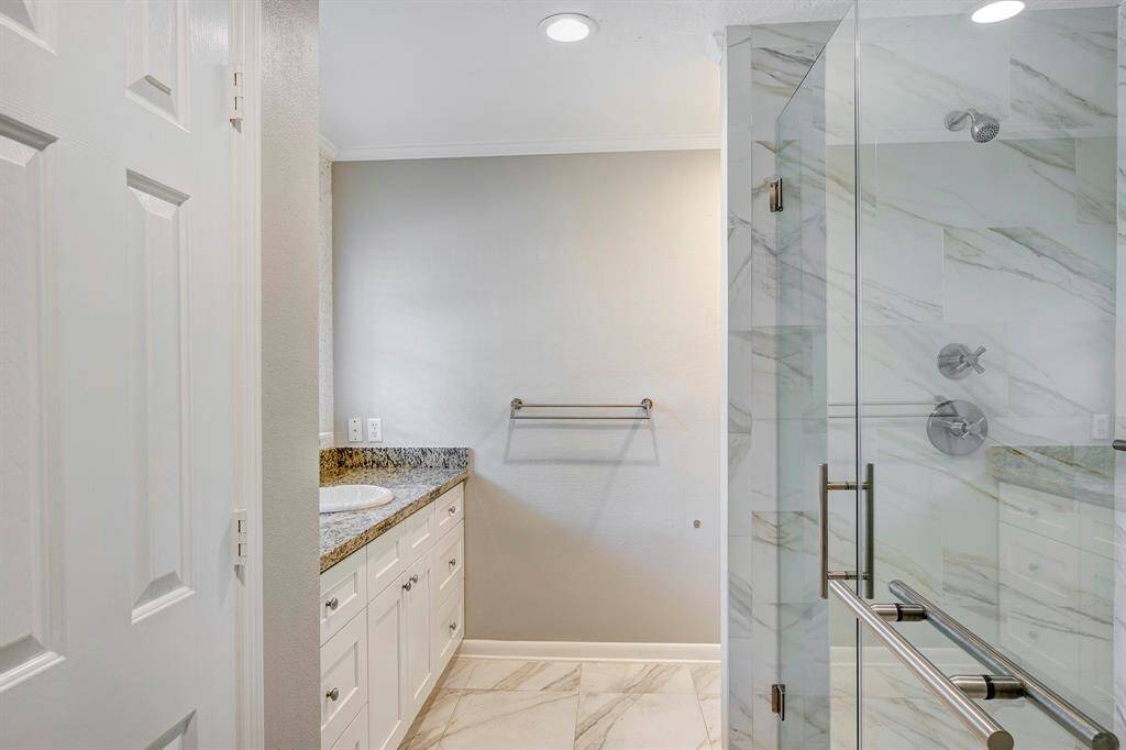 The primary bath is updated and has beautiful marble floors & tile in the oversized shower.