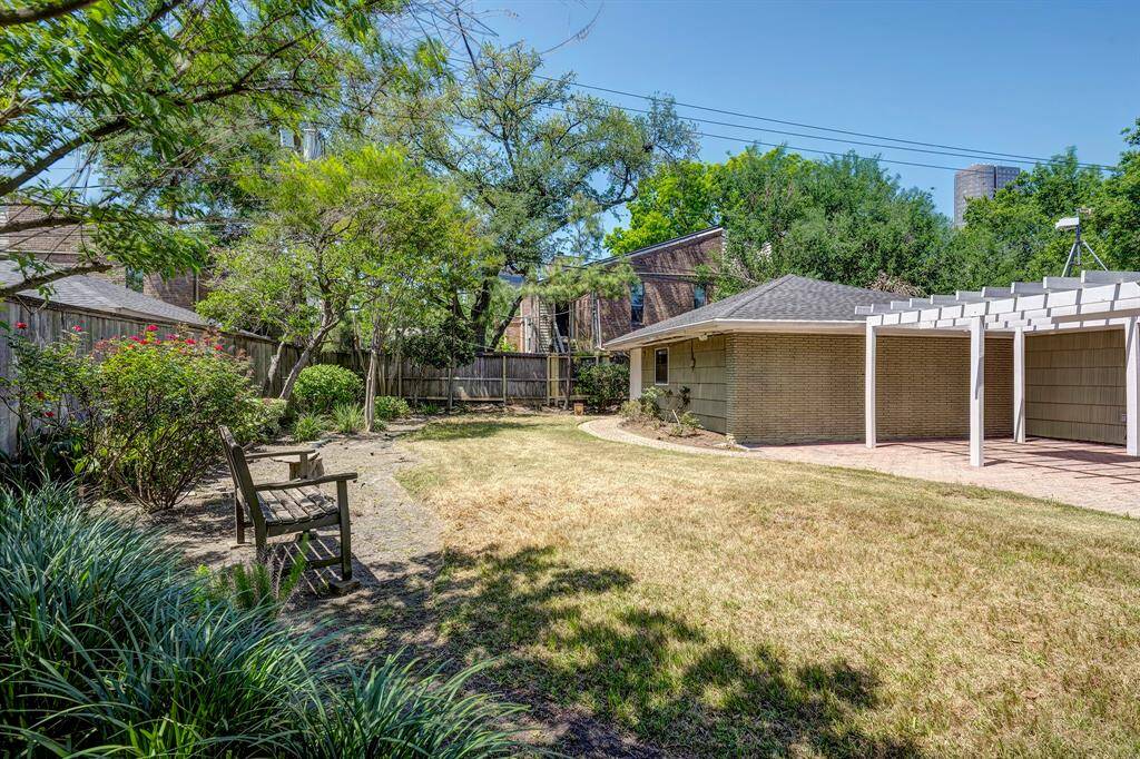 Another view of the yard and the pergola/arbor. It "comes with a weather monitor on a tripod" above the pergola.