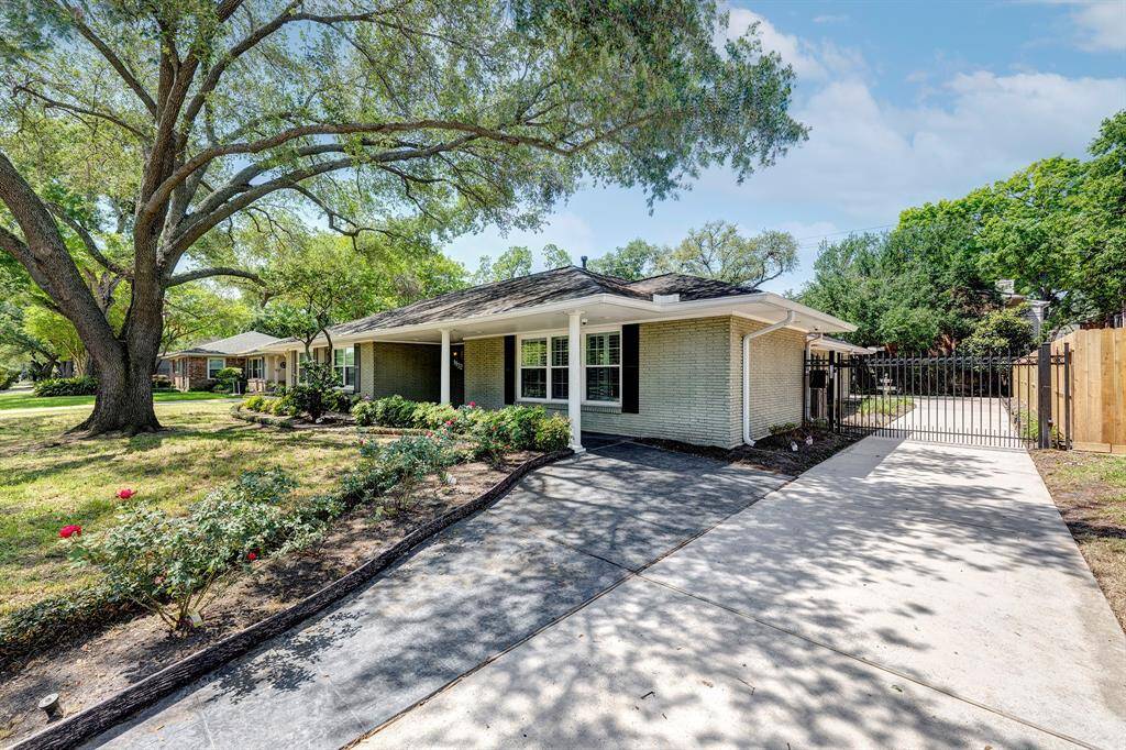 This is a beautiful home, with a stunning mature tree in the front yard, and an automatic gate across the driveway.