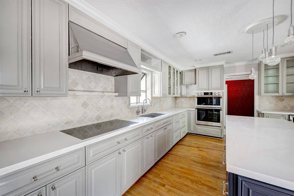 Another view of the kitchen which shows the beautiful tile backsplash on the walls.