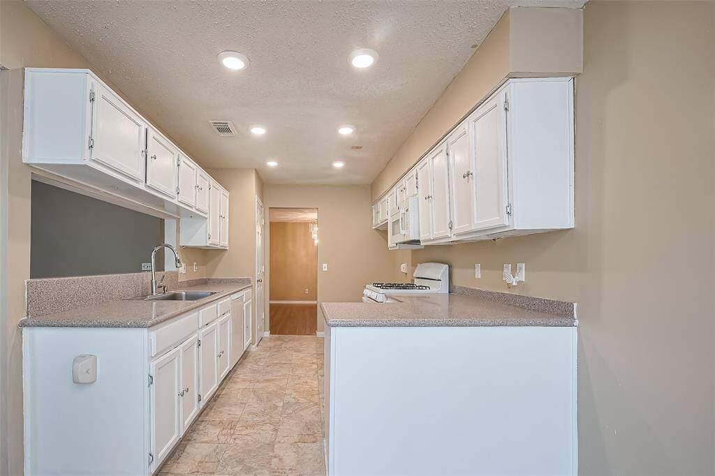 Kitchen, updated with freshly painted white cabinets