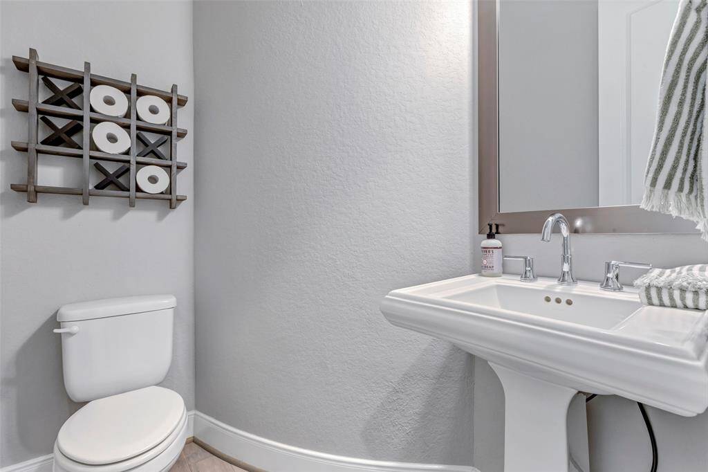 Guest half bath with ornate pedestal sink