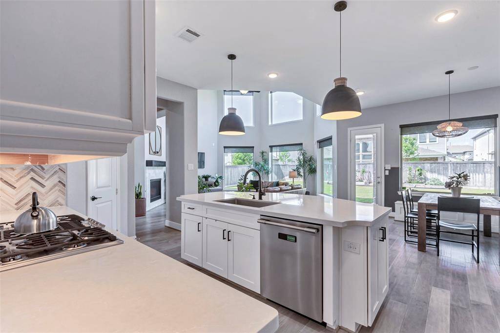 Designer lighting above island and breakfast room