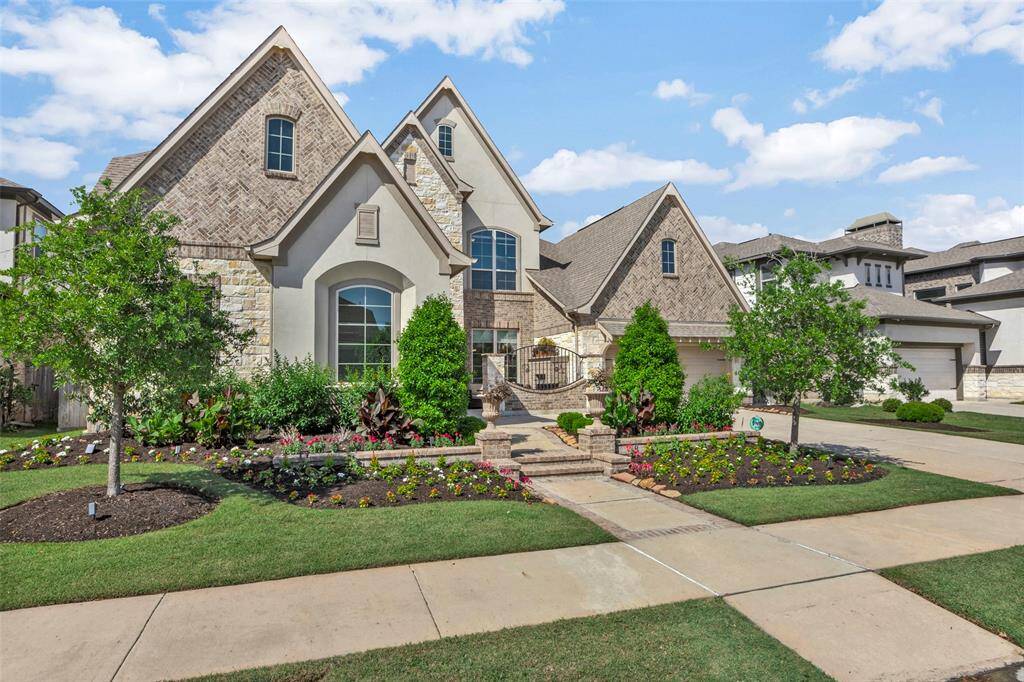 Beautiful design of stone, brick, and stucco elevation, along with custom landscaping