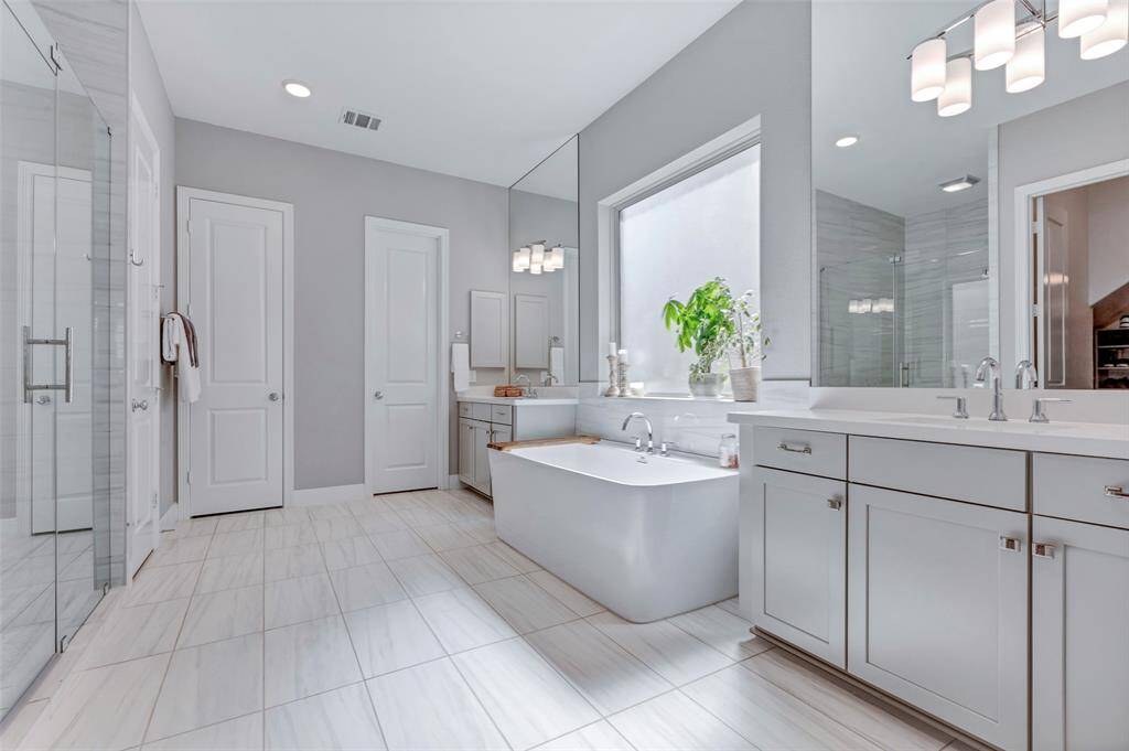 Retreat style primary bathroom with modern soaking tub