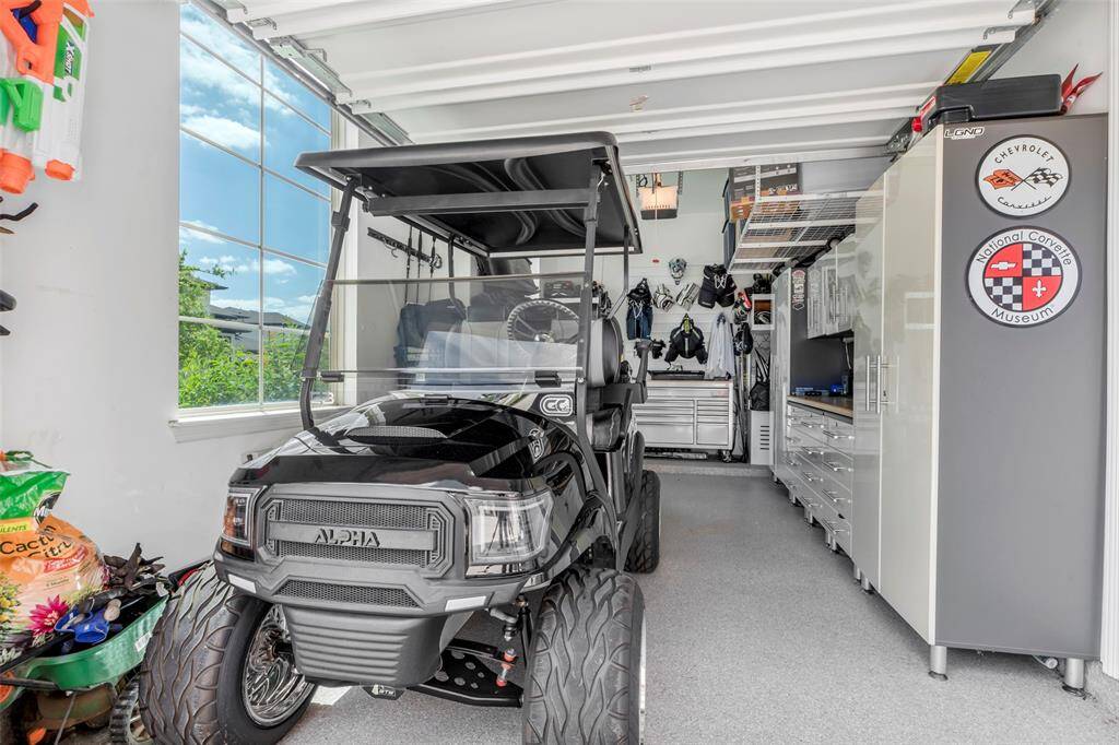Single car garage has been custom fitted with the cabinets to the right that will remain