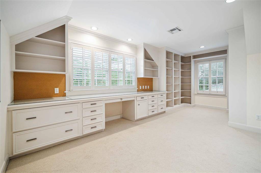 The working office is accessed from the first floor primary suite by a private staircase. Complete with half bath.