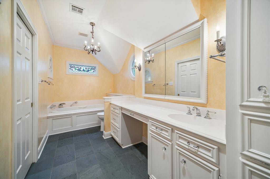 Secondary bath with make-up area and full size tub.