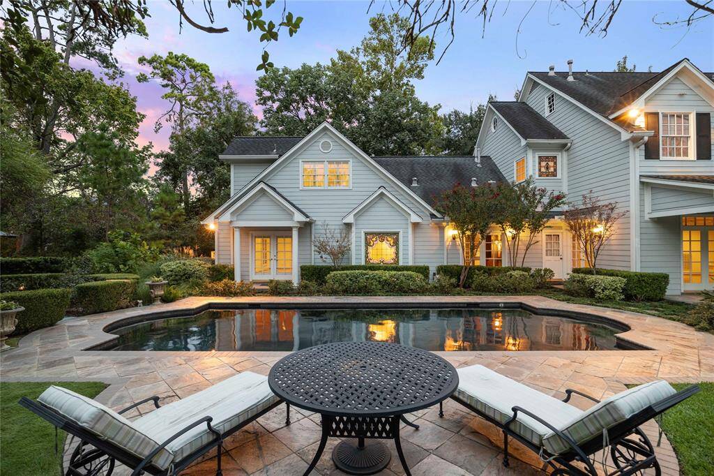 Beautiful architecture enhanced by the elegant pool and surroundings.