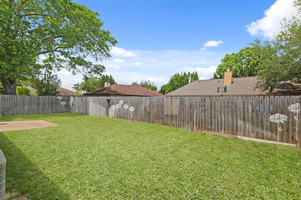 Spacious backyard perfect for games, hanging out, or cultivating your own garden oasis.