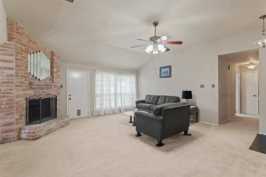 A warm and inviting brick fireplace is the focal point of the room.