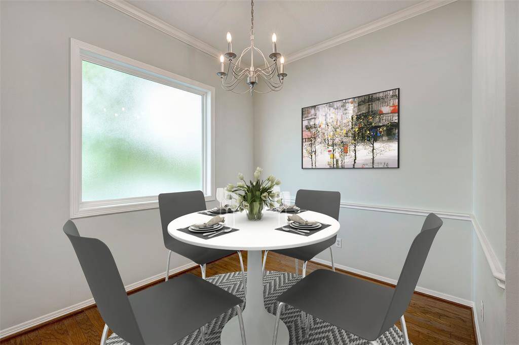 Breakfast room with large picture window. The window is frosted for privacy. Virtually staged photo.