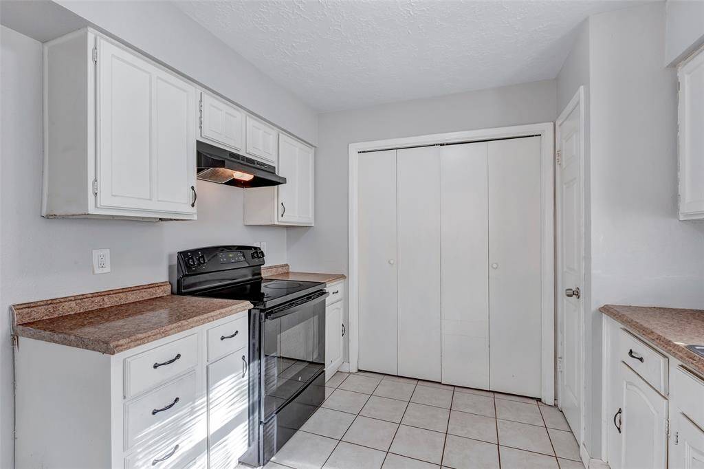 The convenient utility room is discreetly tucked away behind the closed door, offering extra storage and functionality while keeping the living spaces tidy.