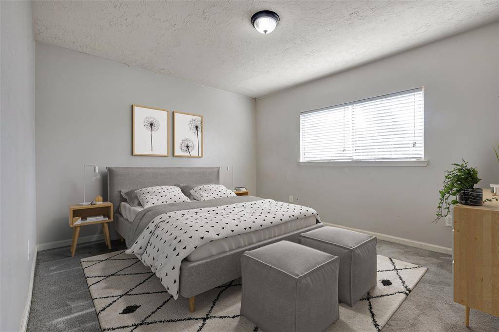Welcome to the primary bedroom, featuring a soft carpeted floor and plenty of space to create a retreat that reflects your personal style and preferences.