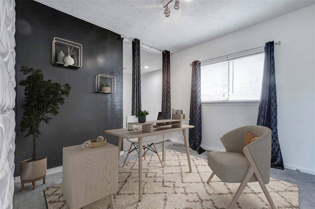 Another secondary room features a plush carpeted floor and a spacious walk-in closet, offering both comfort and convenience. (Virtually Staged)