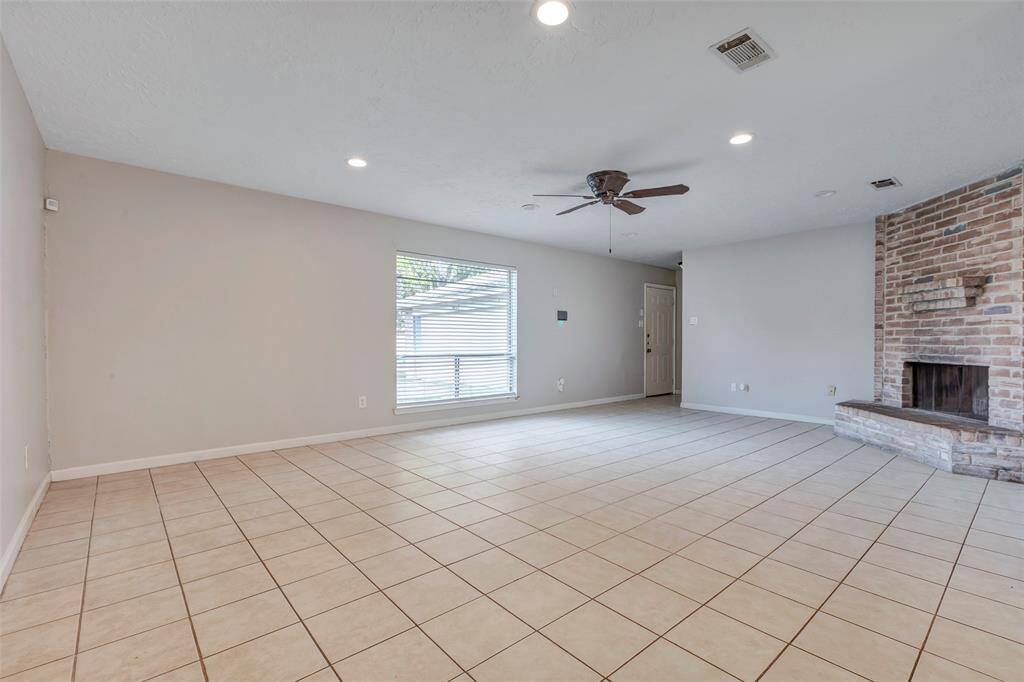 An additional angle showcases the spacious layout of the living room, emphasizing its open feel and comfortable design.