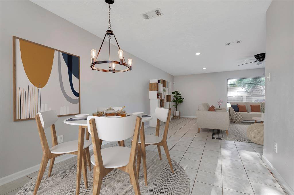 A view from the dining area highlights the open flow into the living room, creating a seamless and connected space. (Virtually Staged)