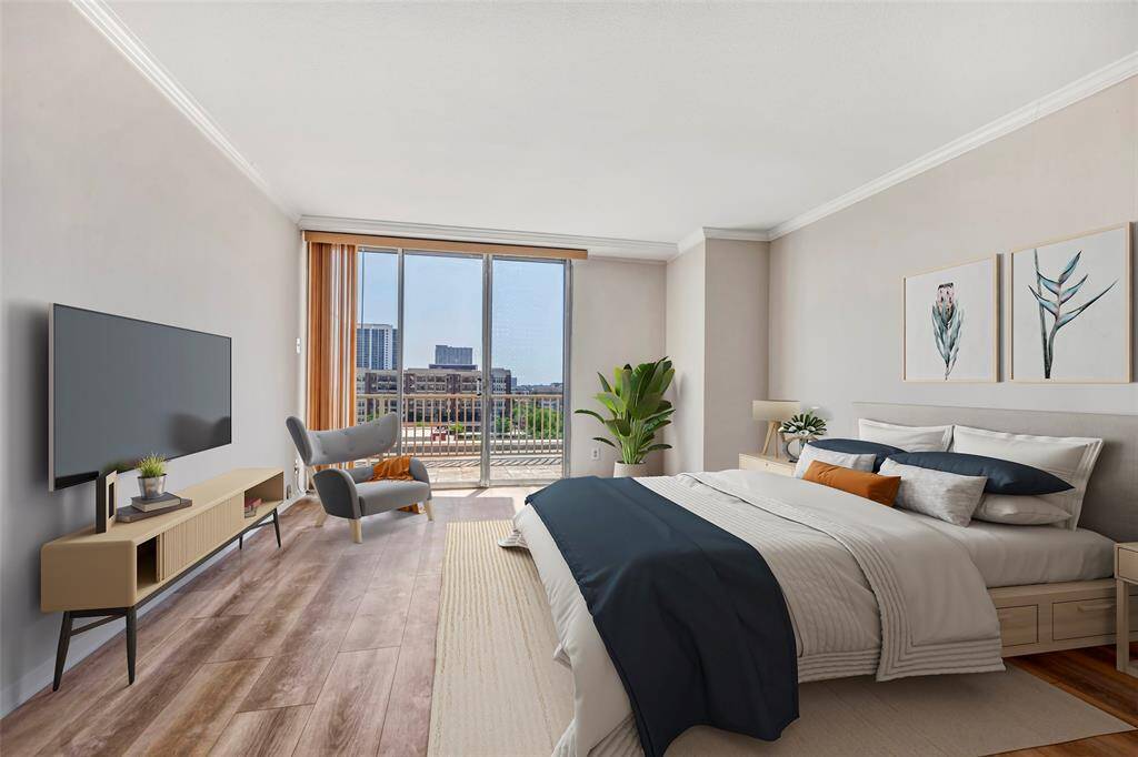 Bright and serene primary bedroom featuring floor-to-ceiling glass doors with views overlooking the building's surroundings. (Virtually Staged)