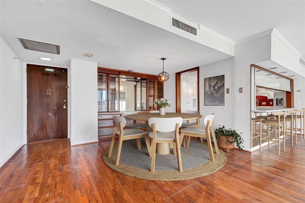 Inviting entryway with a clear view of the dining area and adjacent kitchen. (Virtually Staged)