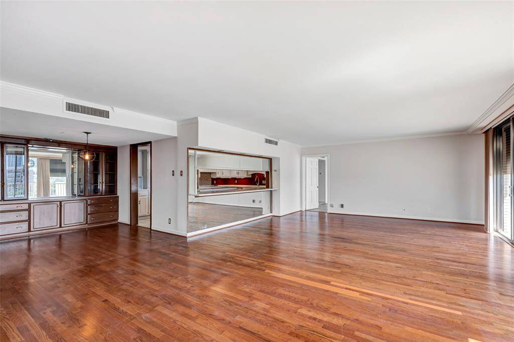 A view of the living room showcasing its open-concept design, seamlessly connecting to the dining area and kitchen.